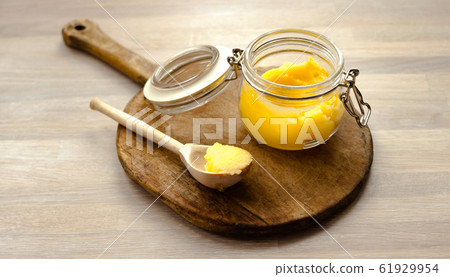 Ghee clarified butter desi in glass jar with spoon 61929954