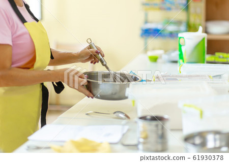 Woman professional pastry chef prepares chocolate Woman professional pastry chef prepares chocolate 61930378
