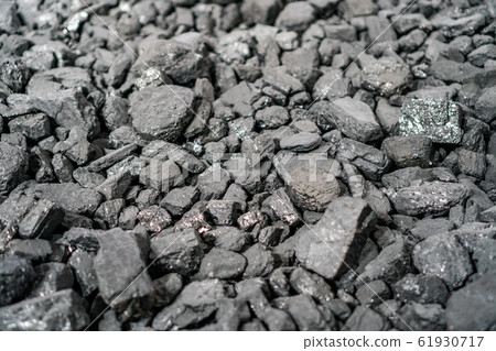 Char-coal. Pattern, heap. Pile of Bituminous Coal cinder. Stone coal Industry, business. Black coal mine close-up with soft focus. Anthracite coal bar 61930717