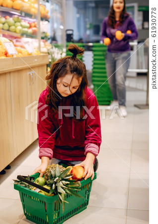 Cute little girl in a supermarket Cute little girl in a supermarket 61930778
