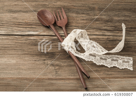 carved spoon and fork on a wooden table 61930807