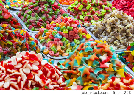 Assortment of jellied colored sweets as a product background Assortment of jellied colored sweets as a product background 61931208