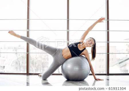 A beautiful girl is engaged in a gym A beautiful girl is engaged in a gym 61931304