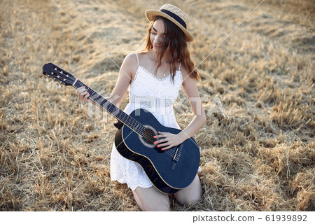 Beautiful elegant girl in a autumn wheat field Beautiful elegant girl in a autumn wheat field 61939892