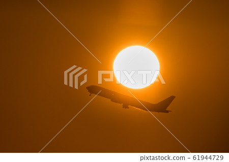 Jet airliner taking off in the morning sun Jet airliner taking off in the morning sun 61944729