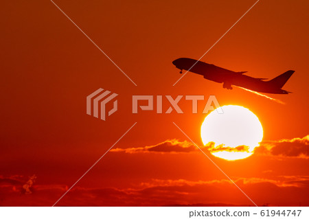Jet airliner taking off in the morning sun Jet airliner taking off in the morning sun 61944747