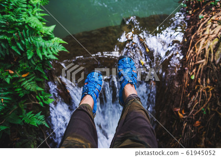 Asian woman travel nature. Travel relax. Top view of the girl's legs wearing blue shoes. Asian woman travel nature. Travel relax. Top view of the girl's legs wearing blue shoes. 61945052