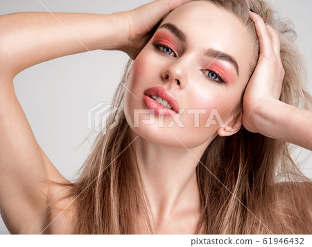 Portrait of a beautiful woman with a coral color Portrait of a beautiful woman with a coral color 61946432