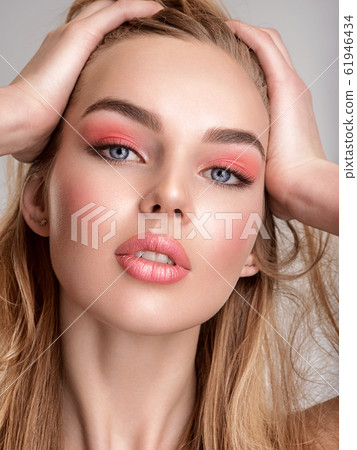 Portrait of a beautiful woman with a coral color Portrait of a beautiful woman with a coral color 61946434