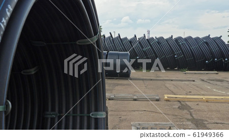 Warehouse of finished plastic pipes industrial outdoors storage site. Manufacture of plastic water pipes factory. Warehouse of finished plastic pipes industrial outdoors storage site. Manufacture of plastic water pipes factory. 61949366