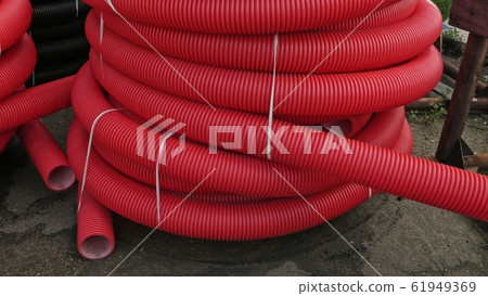 Warehouse of finished plastic pipes industrial outdoors storage site. Manufacture of plastic water pipes factory. 61949369