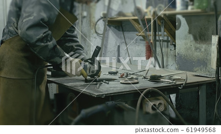 Forge workshop on table. Smithy manual production. Work on the product. Ruler, angle grinder. The blacksmith manufacture of fireplaces, stoves. 61949568