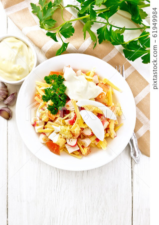 Salad of surimi and tomatoes with eggs Salad of surimi and tomatoes with eggs 61949984