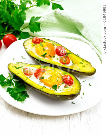 Scrambled eggs with tomatoes in avocado 61949993