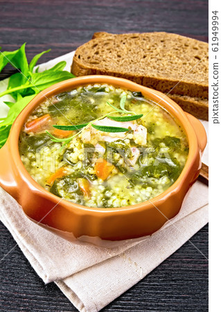 Soup with couscous and spinach in clay bowl Soup with couscous and spinach in clay bowl 61949994