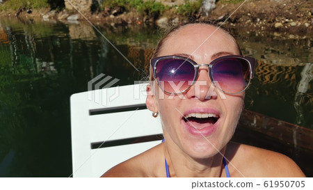 Woman shooting self portrait. Take photo and video on smartphone. Girl rest, relax, walk in sunglasses, make selfie. Blogger broadcast video vlogging. Woman shooting self portrait. Take photo and video on smartphone. Girl rest, relax, walk in sunglasses, make selfie. Blogger broadcast video vlogging. 61950705