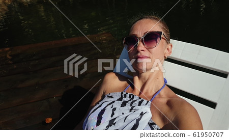 Woman shooting self portrait. Take photo and video on smartphone. Girl rest, relax, walk in sunglasses, make selfie. Blogger broadcast video vlogging. Woman shooting self portrait. Take photo and video on smartphone. Girl rest, relax, walk in sunglasses, make selfie. Blogger broadcast video vlogging. 61950707