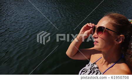 Woman shooting self portrait. Take photo and video on smartphone. Girl rest, relax, walk in sunglasses, make selfie. Blogger broadcast video vlogging. Woman shooting self portrait. Take photo and video on smartphone. Girl rest, relax, walk in sunglasses, make selfie. Blogger broadcast video vlogging. 61950708