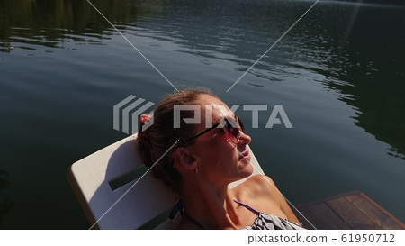 Woman shooting self portrait. Take photo and video on smartphone. Girl rest, relax, walk in sunglasses, make selfie. Blogger broadcast video vlogging. Woman shooting self portrait. Take photo and video on smartphone. Girl rest, relax, walk in sunglasses, make selfie. Blogger broadcast video vlogging. 61950712