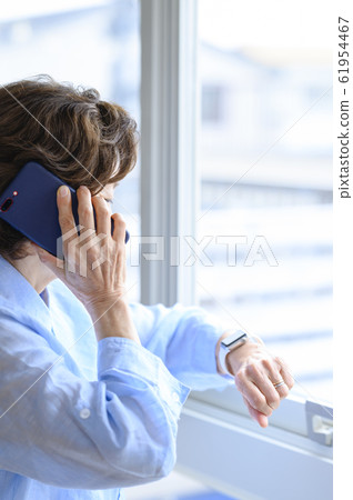 Senior woman using smart watch 61954467