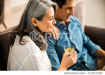 Beautiful adult woman with glass of water near her husband Beautiful adult woman with glass of water near her husband 61955369