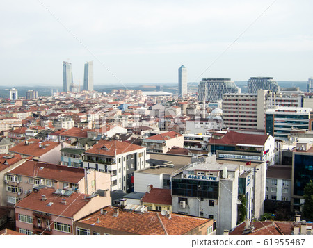 Istanbul cityscape-brown roof houses and modern glass skyscrapers and mosques in the distance 61955487