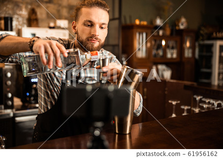 Young bartender filming vlog about his work 61956162
