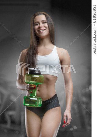 Fitness woman drinking water at workout in the gym Fitness woman drinking water at workout in the gym 61956953