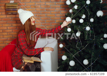 Girl near Christmas tree Girl near Christmas tree 61957109