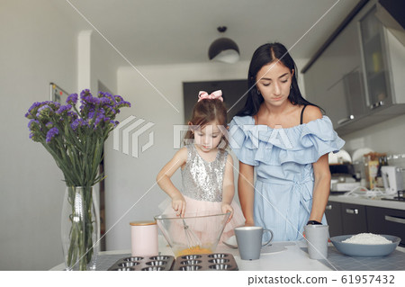 Family sitting in a kitchen and cook the dough for cookies 61957432