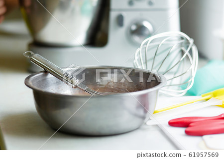 Woman professional pastry chef prepares chocolate Woman professional pastry chef prepares chocolate 61957569