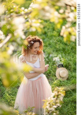 Young attractive girl walks in spring green park Young attractive girl walks in spring green park 61958184