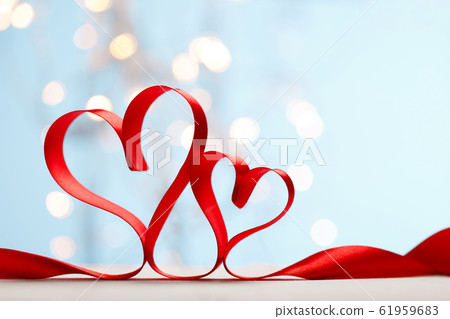 Ribbon shaped as hearts on blue background with lights Ribbon shaped as hearts on blue background with lights 61959683