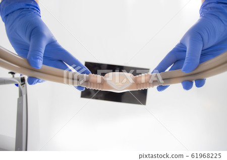 An anesthetist hands the patient under anesthesia 61968225