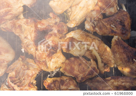 Grilled Crispy Chicken Meat On Smoking Barbecue With Rosemary  61968800