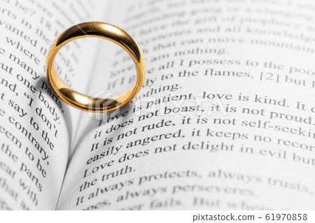 Golden wedding ring on bible book Golden wedding ring on bible book 61970858