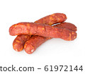 Stack of cooked sausages close-up isolated. 61972144