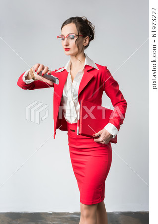 Businesswoman being late to her meeting checking the time 61973222