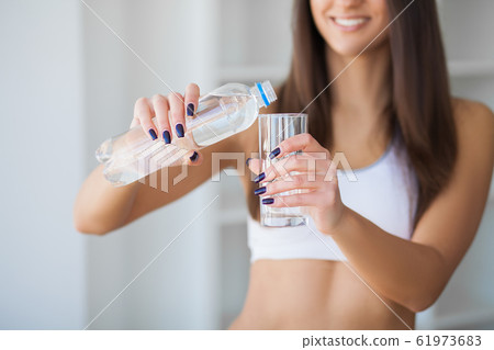 Portrait Of Happy Smiling Young Woman With Bottle Of Fresh Water 61973683