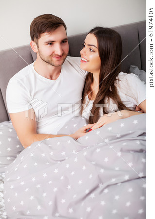 Intimate sensual young couple in bedroom enjoying each other 61974105