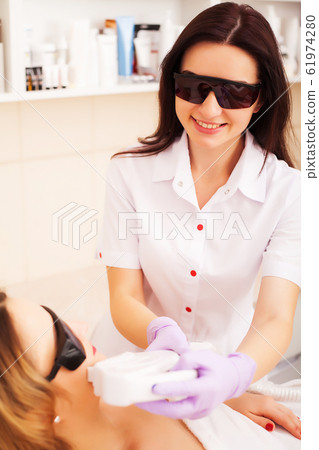 Beautician Giving Laser Epilation Treatment To Young Woman's Face At Beauty Clinic. 61974280