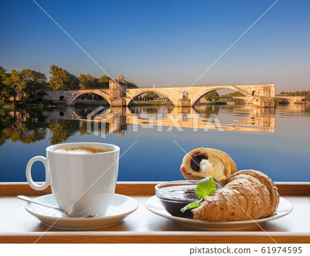 Coffee with croissants against Avignon old bridge in Provence, France 61974595