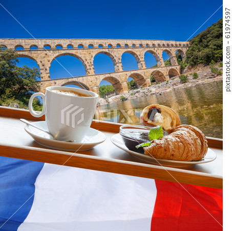 Coffee with croissants against Pont du Gard, is an old Roman aqueduct in Provence, France 61974597