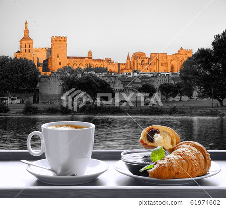 Coffee with croissants against Avignon town in Provence, France Coffee with croissants against Avignon town in Provence, France 61974602