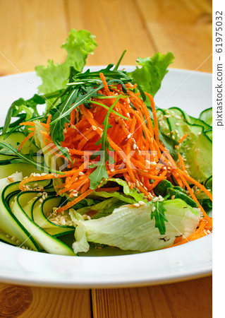 Macro photo of salad with cucumber, spicy carrot Macro photo of salad with cucumber, spicy carrot 61975032