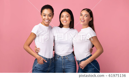Three Women Embracing Standing In Studio On Pink Background, Panorama Three Women Embracing Standing In Studio On Pink Background, Panorama 61975136