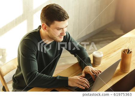 Copywriter Man Working At Laptop Computer In Modern Office, High-Angle Copywriter Man Working At Laptop Computer In Modern Office, High-Angle 61975363
