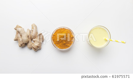 Turmeric powder and ginger root on white background 61975571