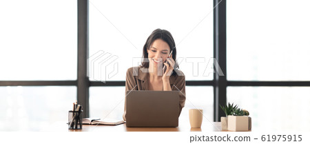 Portrait of smiling manager making phone call Portrait of smiling manager making phone call 61975915
