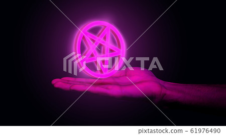 Male hand holding adverse pentagram at studio 61976490